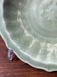A Chinese Longquan celadon lotus-form dish with underglaze floral design, Ming