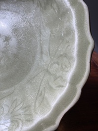 A Chinese Longquan celadon lotus-form dish with underglaze floral design, Ming