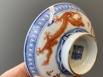 A Chinese blue, white and iron-red 'dragon' bowl and cover and a wine cup, Qianlong mark, 18/19th C.