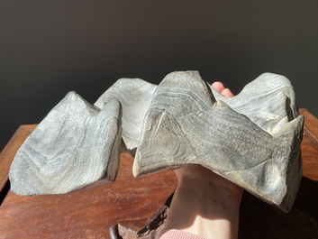 A Chinese grey lingbi stone scholar's rock on wooden stand, 19/20th C.