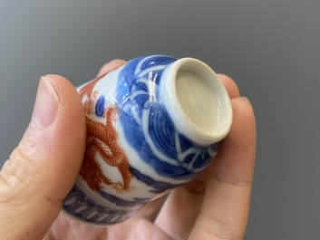 A Chinese blue, white and iron-red 'dragon' bowl and cover and a wine cup, Qianlong mark, 18/19th C.