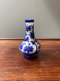 A Chinese overlay Beijing glass bottle vase with lotus scrolls in blue on white, 19th C.