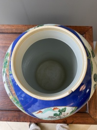 A pair of Chinese powder-blue-ground famille verte vases and covers, 19th C.
