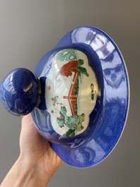 A pair of Chinese powder-blue-ground famille verte vases and covers, 19th C.