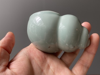 A Chinese celadon-glazed water pot on wooden stand and a small 'hu' vase, 19/20th C.