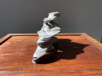 A Chinese grey lingbi stone scholar's rock on wooden stand, 19/20th C.