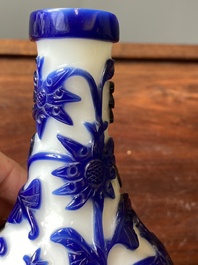 A Chinese overlay Beijing glass bottle vase with lotus scrolls in blue on white, 19th C.