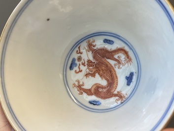 A Chinese blue, white and iron-red 'dragon' bowl and cover and a wine cup, Qianlong mark, 18/19th C.