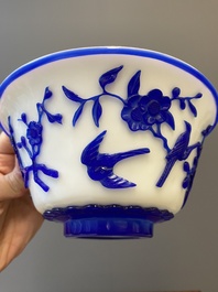 A Chinese overlay Beijing glass 'magpie and plum blossom' bowl in blue on white, 19th C.