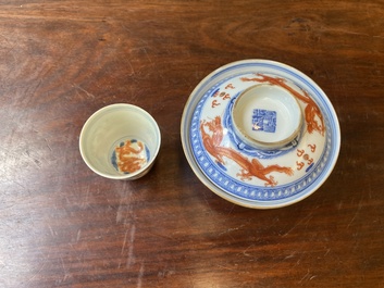 A Chinese blue, white and iron-red 'dragon' bowl and cover and a wine cup, Qianlong mark, 18/19th C.