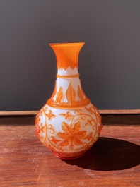 A Chinese overlay Beijing glass bottle vase with lotus scrolls in yellow on white, 19t/20h C.