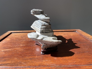 A Chinese grey lingbi stone scholar's rock on wooden stand, 19/20th C.