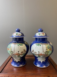 A pair of Chinese powder-blue-ground famille verte vases and covers, 19th C.