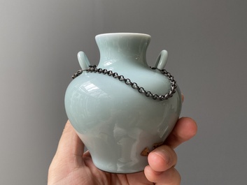 A Chinese celadon-glazed water pot on wooden stand and a small 'hu' vase, 19/20th C.