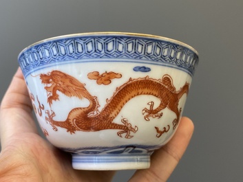 A Chinese blue, white and iron-red 'dragon' bowl and cover and a wine cup, Qianlong mark, 18/19th C.