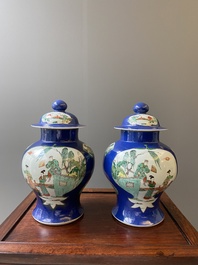 A pair of Chinese powder-blue-ground famille verte vases and covers, 19th C.