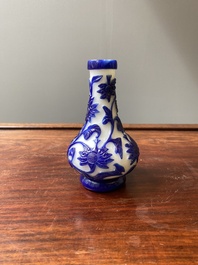 A Chinese overlay Beijing glass bottle vase with lotus scrolls in blue on white, 19th C.