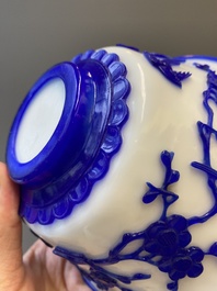 A Chinese overlay Beijing glass 'magpie and plum blossom' bowl in blue on white, 19th C.