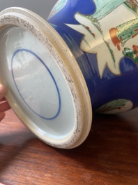 A pair of Chinese powder-blue-ground famille verte vases and covers, 19th C.