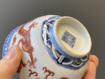 A Chinese blue, white and iron-red 'dragon' bowl and cover and a wine cup, Qianlong mark, 18/19th C.