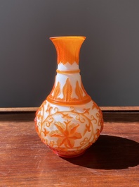A Chinese overlay Beijing glass bottle vase with lotus scrolls in yellow on white, 19t/20h C.