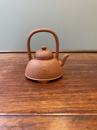 Een Chinese Yixing steengoed theepot met gekerfd decor van chrysanten, Kangxi