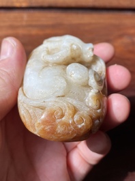Een Chinese witte en roestkleurige jade hanger in de vorm van een buffel, 19e eeuw