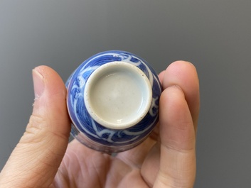 A Chinese blue, white and iron-red 'dragon' bowl and cover and a wine cup, Qianlong mark, 18/19th C.