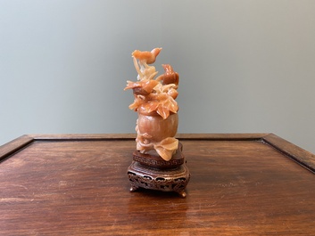 A Chinese carnelian agate sculpture of a vase with branches and birds, 20th C.