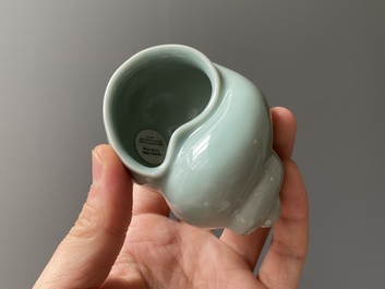 A Chinese celadon-glazed water pot on wooden stand and a small 'hu' vase, 19/20th C.
