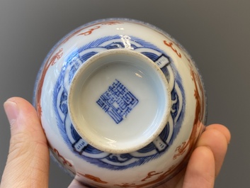 A Chinese blue, white and iron-red 'dragon' bowl and cover and a wine cup, Qianlong mark, 18/19th C.