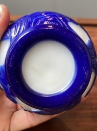 A Chinese overlay Beijing glass bottle vase with lotus scrolls in blue on white, 19th C.