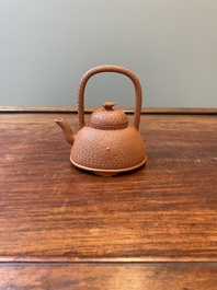 Een Chinese Yixing steengoed theepot met gekerfd decor van chrysanten, Kangxi