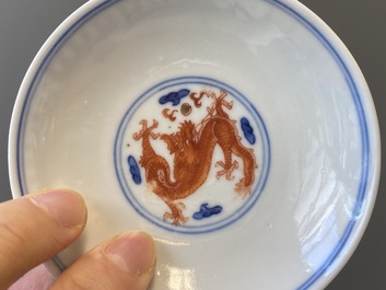A Chinese blue, white and iron-red 'dragon' bowl and cover and a wine cup, Qianlong mark, 18/19th C.