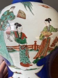 A pair of Chinese powder-blue-ground famille verte vases and covers, 19th C.