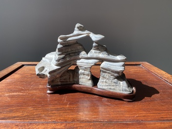 A Chinese grey lingbi stone scholar's rock on wooden stand, 19/20th C.