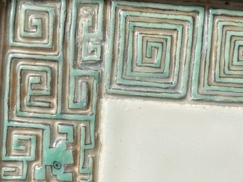 A Chinese relief-decorated famille verte 'peacock' plaque in a fine carved hongmu wooden frame, 19th C.