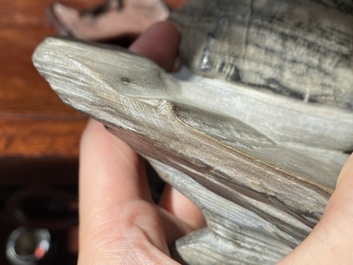 A Chinese grey lingbi stone scholar's rock on wooden stand, 19/20th C.
