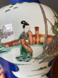 A pair of Chinese powder-blue-ground famille verte vases and covers, 19th C.