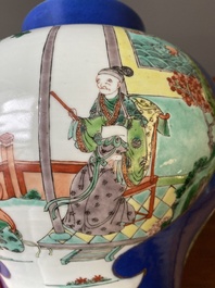 A pair of Chinese powder-blue-ground famille verte vases and covers, 19th C.