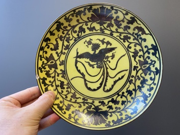 Een Chinees famille rose bord met vijf perziken en een bord met een feniks op gele fondkleur, Song Feng Yong Le 松風永樂 merk, 18/19e eeuw