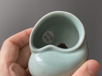 A Chinese celadon-glazed water pot on wooden stand and a small 'hu' vase, 19/20th C.