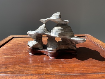A Chinese grey lingbi stone scholar's rock on wooden stand, 19/20th C.