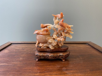 A Chinese carnelian agate sculpture of a vase with branches and birds, 20th C.