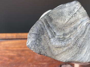 A Chinese grey lingbi stone scholar's rock on wooden stand, 19/20th C.