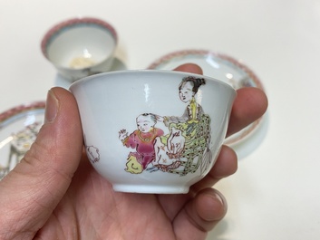 A pair of Chinese famille rose cups and saucers with a lady and a boy, Yongzheng