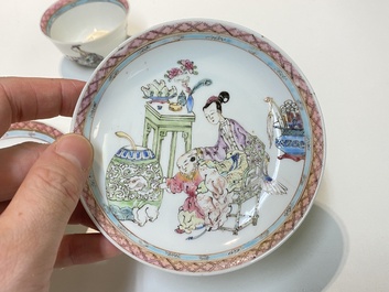 A pair of Chinese famille rose cups and saucers with a lady and a boy, Yongzheng