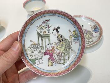 A pair of Chinese famille rose cups and saucers with a lady and a boy, Yongzheng