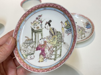A pair of Chinese famille rose cups and saucers with a lady and a boy, Yongzheng