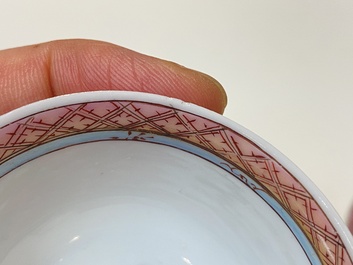 A pair of Chinese famille rose cups and saucers with a lady and a boy, Yongzheng